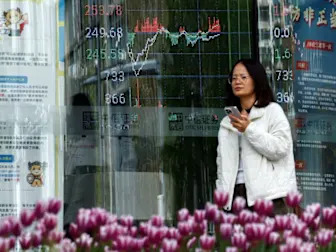 Asian stocks inch higher, Aussie dips as RBA cuts rates